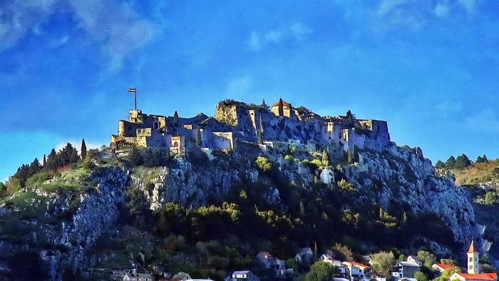 Klis Fortress seen from the south-west, perched on its rocky ridge above the village of Klis